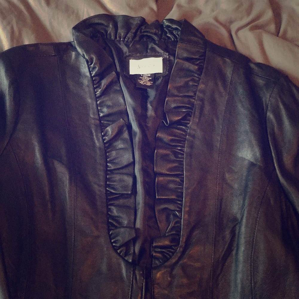 Black leather jacket with ruffled collar.